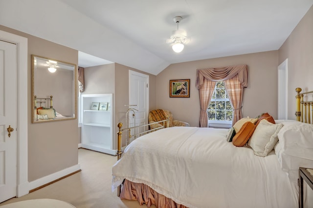 carpeted bedroom with vaulted ceiling