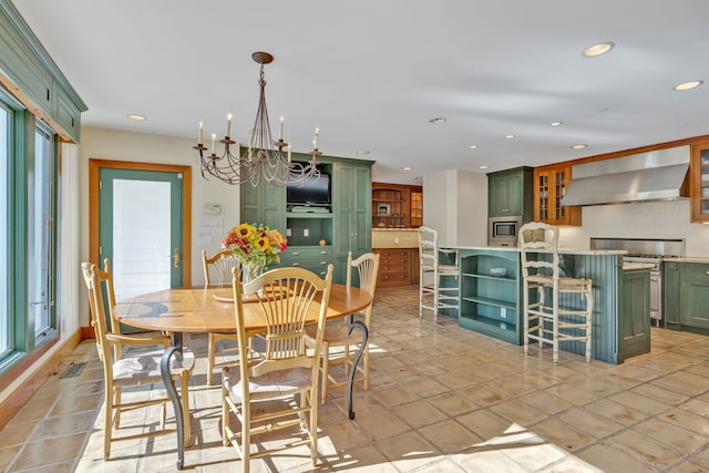 tiled dining area with a chandelier