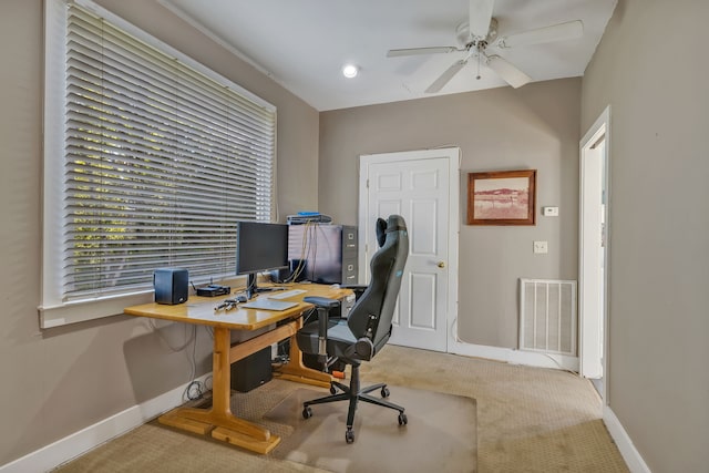 carpeted office featuring ceiling fan