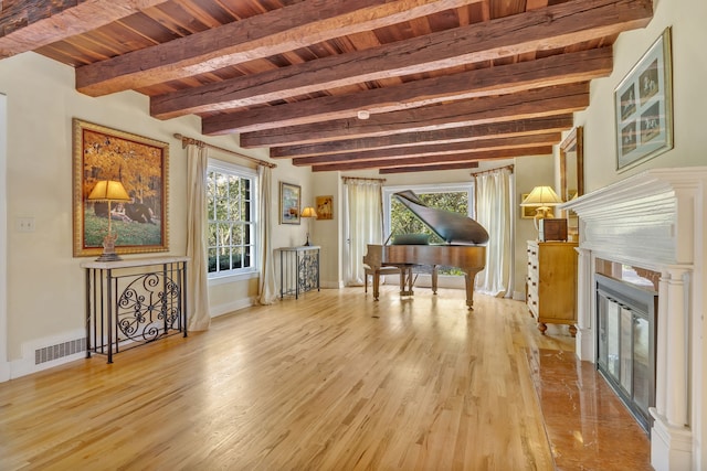 miscellaneous room featuring light wood-type flooring, beamed ceiling, and wood ceiling