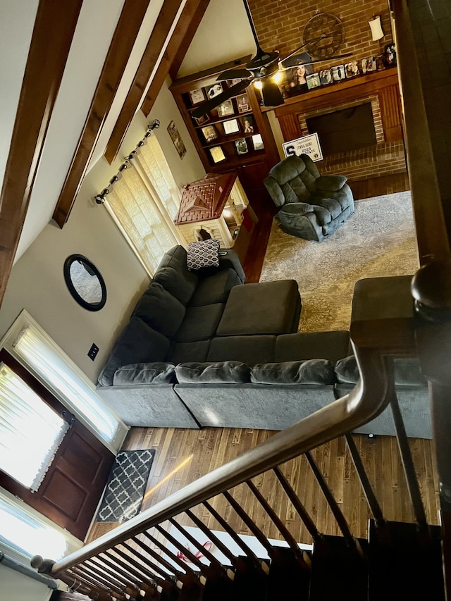 interior space with carpet floors, wooden walls, ceiling fan, high vaulted ceiling, and beam ceiling