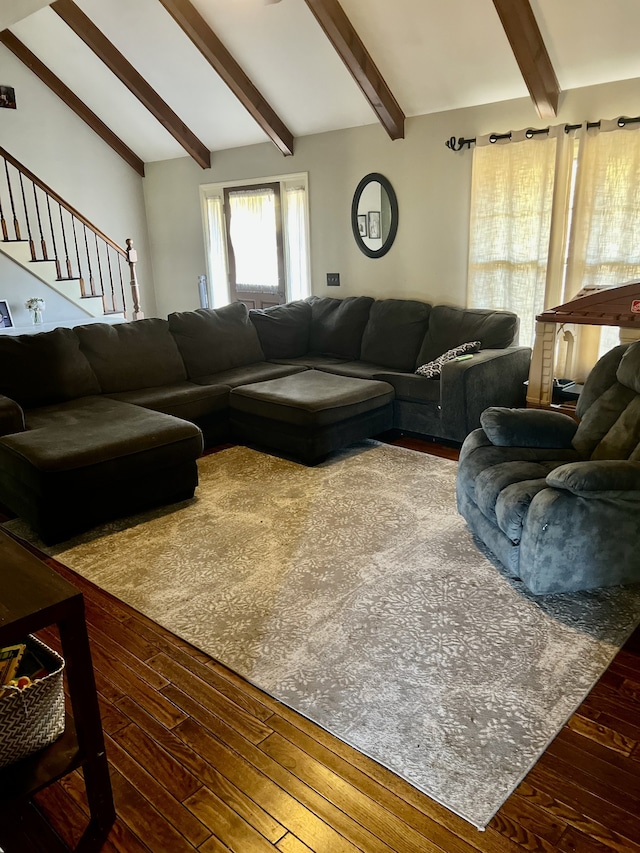 living room with vaulted ceiling with beams and dark wood-type flooring