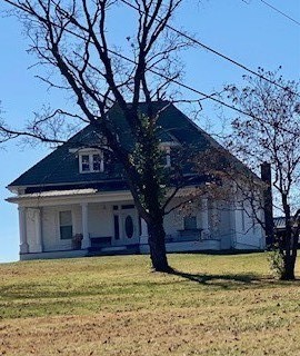 view of front of house with covered porch and a front yard