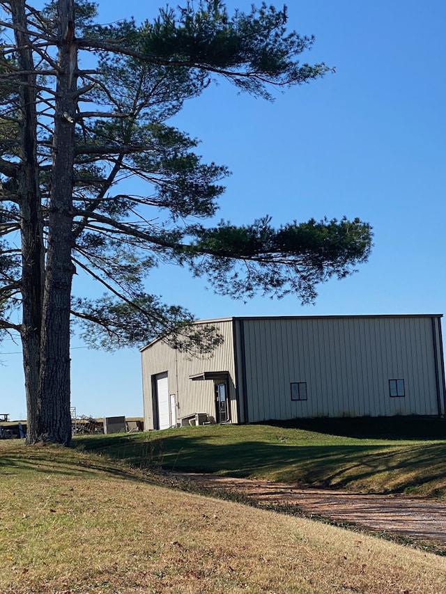 view of outbuilding featuring a lawn