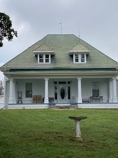 exterior space with a lawn and a porch