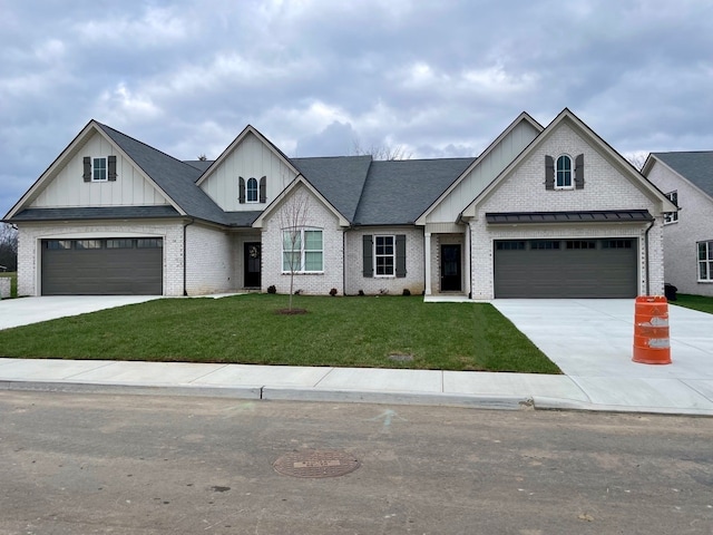 view of front of property featuring a garage and a front lawn