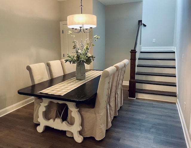 dining room with a notable chandelier and dark wood-type flooring