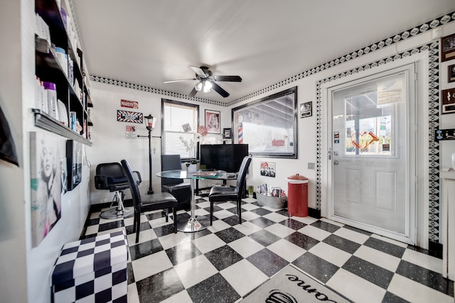 office space featuring ceiling fan and dark tile flooring