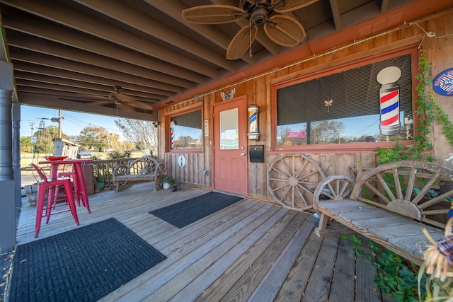 wooden terrace featuring ceiling fan