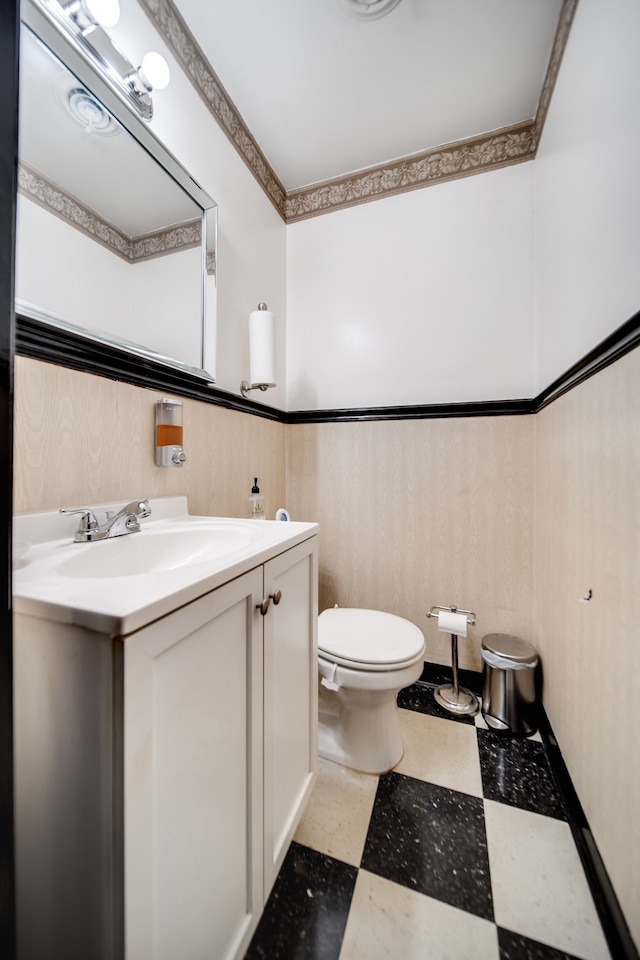 bathroom with tile flooring, toilet, and vanity