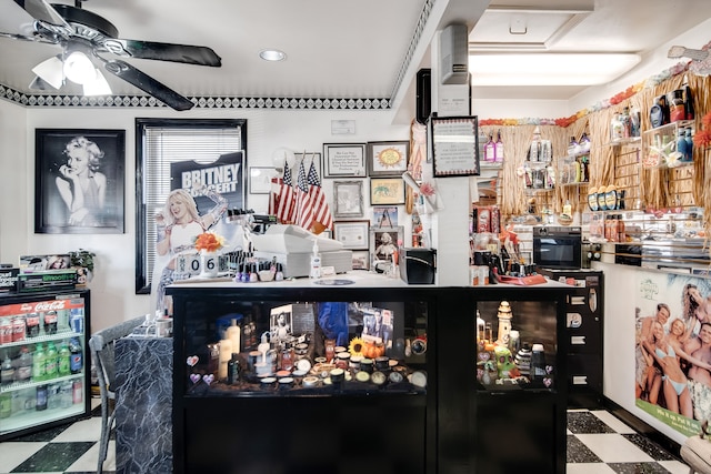 bar with ceiling fan and dark tile flooring