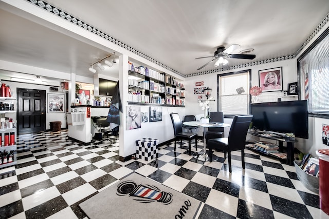 dining area with dark tile floors, ceiling fan, and track lighting