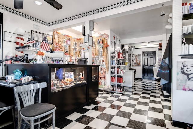 bar featuring dark tile floors and ceiling fan