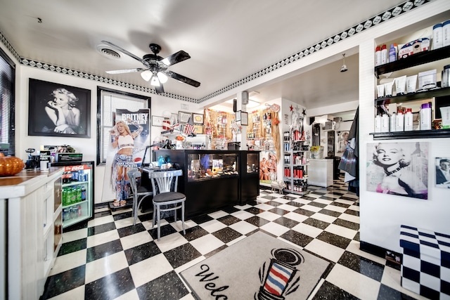 interior space featuring ceiling fan and dark tile flooring