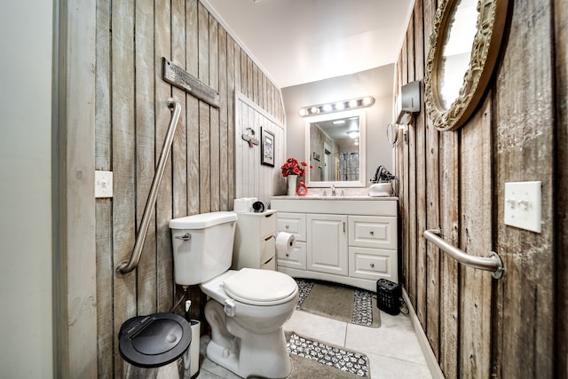 bathroom featuring toilet, tile flooring, and vanity