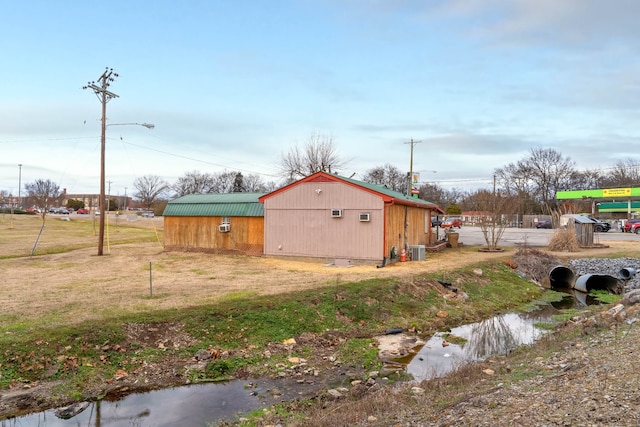 view of yard featuring central AC and an outdoor structure