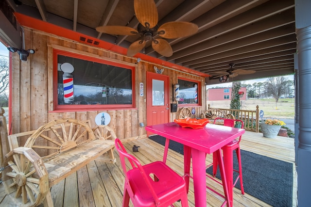 wooden deck featuring ceiling fan