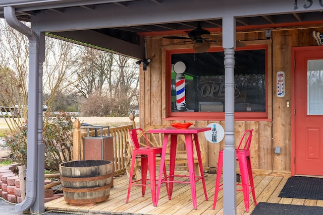 wooden deck featuring ceiling fan