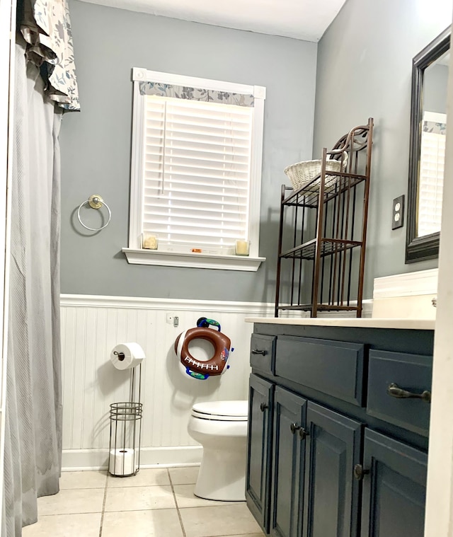 bathroom with vanity, toilet, and tile patterned flooring