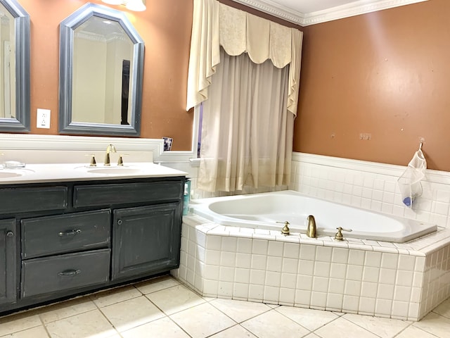 bathroom with tile patterned flooring, tiled bath, crown molding, and vanity