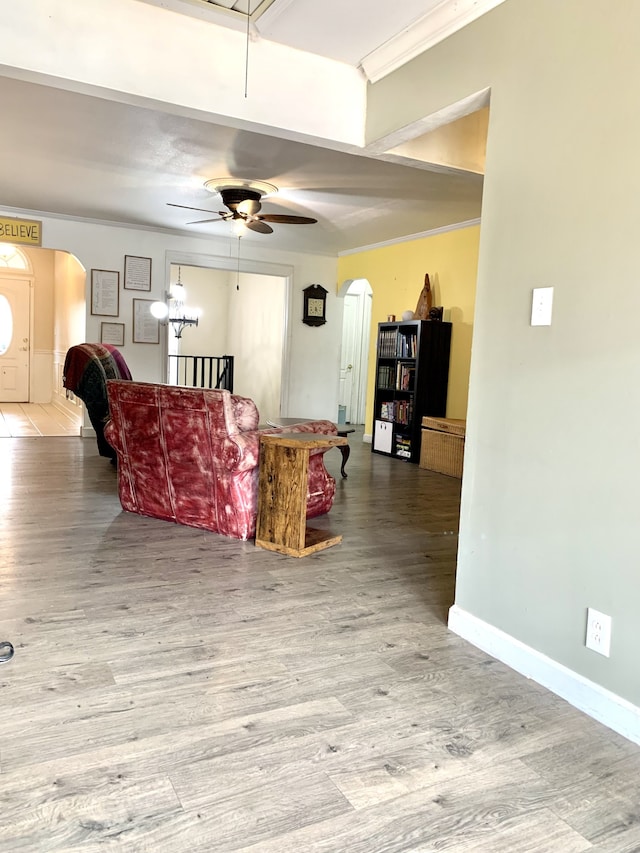 living room featuring ceiling fan with notable chandelier and hardwood / wood-style floors