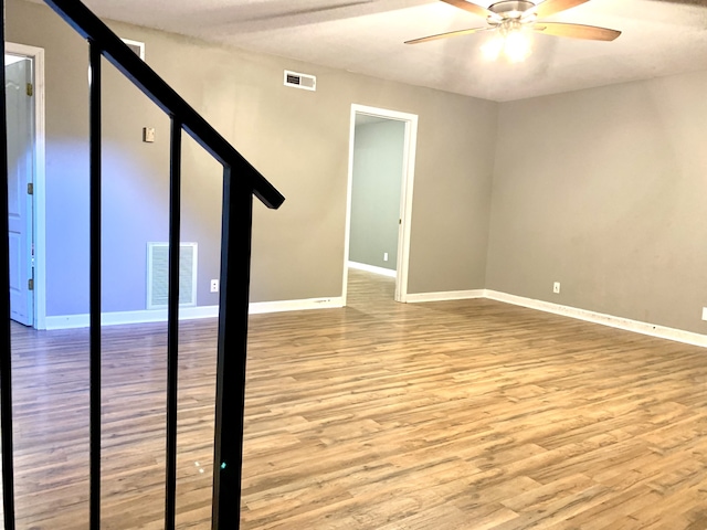 unfurnished room featuring ceiling fan and wood-type flooring