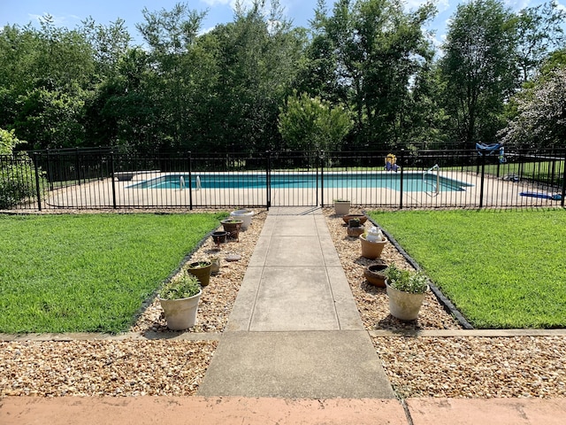 view of pool featuring a yard