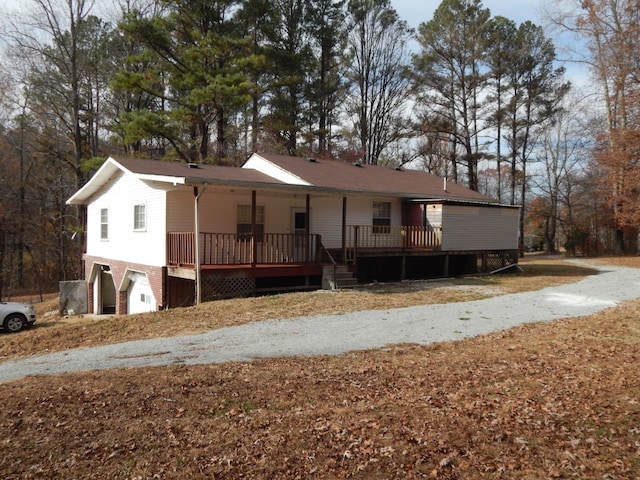 view of front of property featuring a porch and a garage