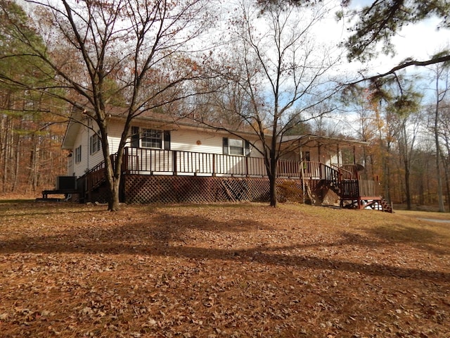 rear view of house with a wooden deck