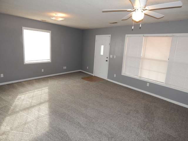 spare room featuring carpet flooring and ceiling fan