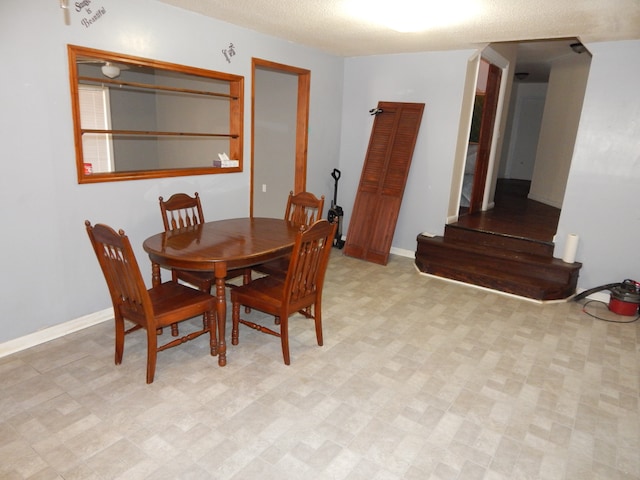 dining area featuring a textured ceiling