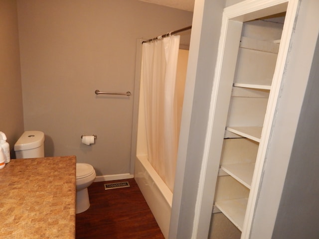 bathroom featuring shower / bath combo, toilet, and wood-type flooring