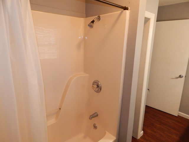 bathroom featuring hardwood / wood-style floors and shower / tub combo