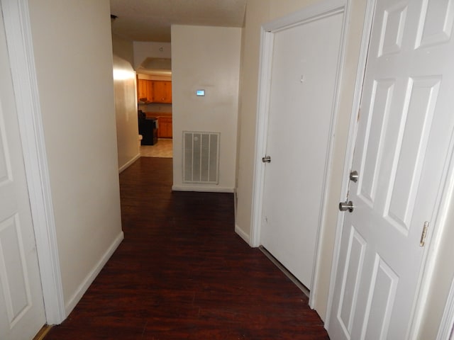 corridor featuring dark hardwood / wood-style flooring