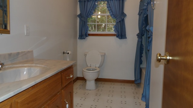 bathroom with tile floors, toilet, and vanity