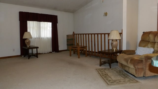 sitting room featuring light carpet and vaulted ceiling