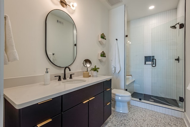 bathroom featuring walk in shower, toilet, and vanity