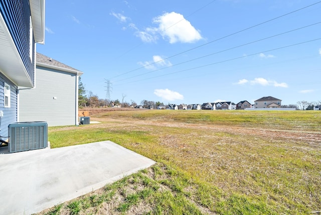 view of yard featuring a patio area and central AC