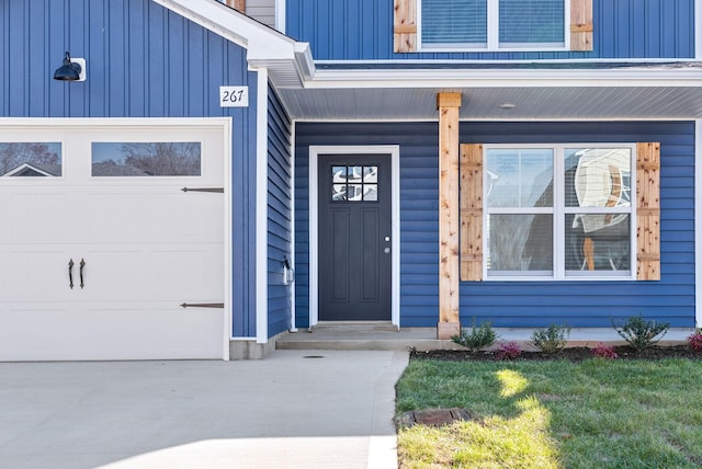 doorway to property with a garage