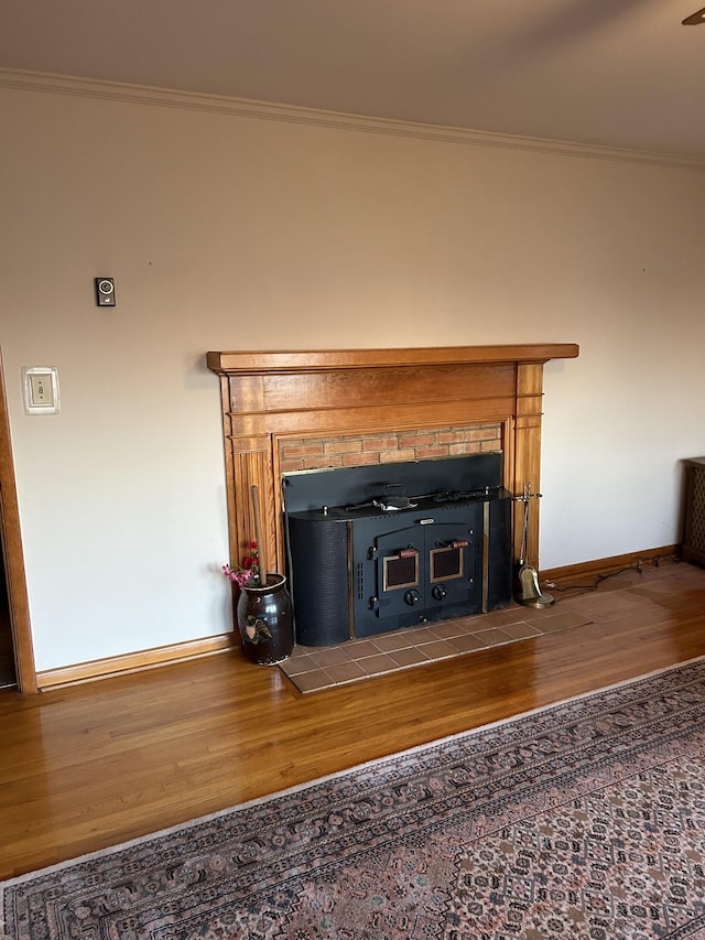 interior details with crown molding, a fireplace, and hardwood / wood-style floors