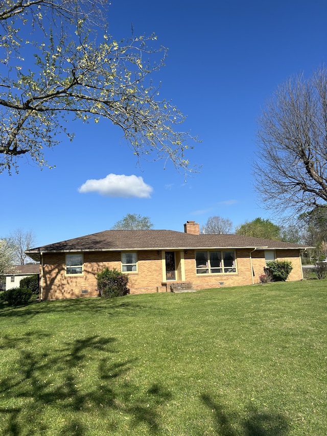 rear view of house with a lawn