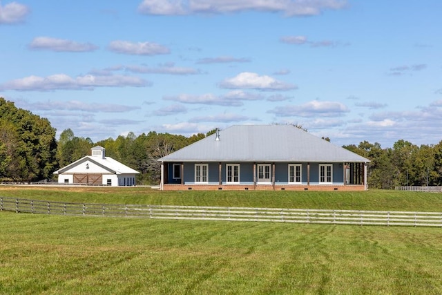 ranch-style house with a front yard and a rural view