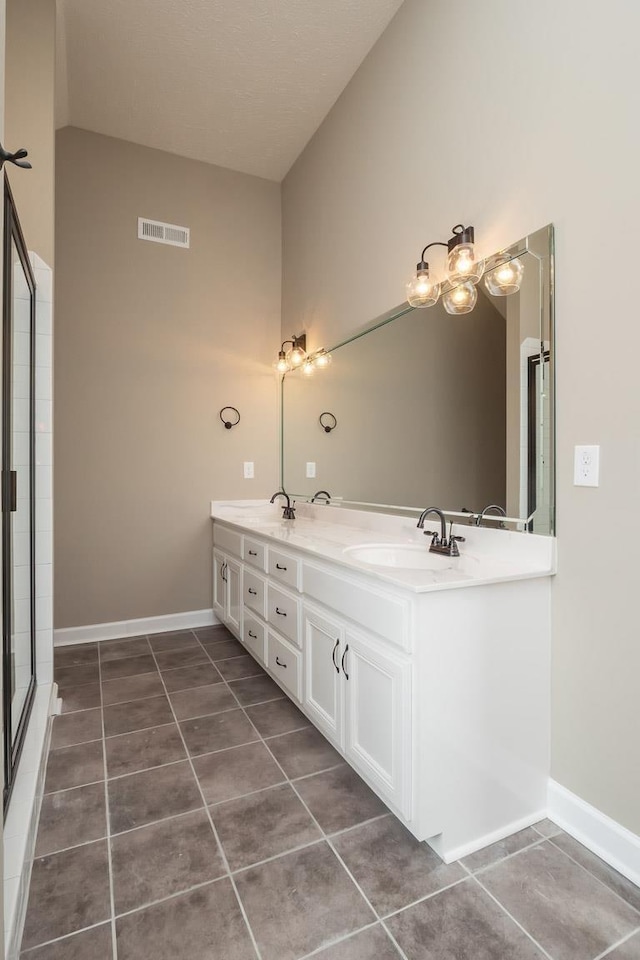 bathroom featuring tile patterned flooring, vanity, a shower with door, and high vaulted ceiling