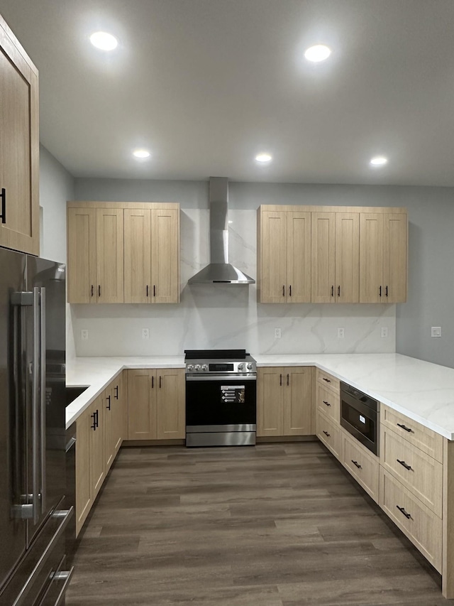 kitchen featuring appliances with stainless steel finishes, dark wood-type flooring, wall chimney range hood, and light brown cabinetry