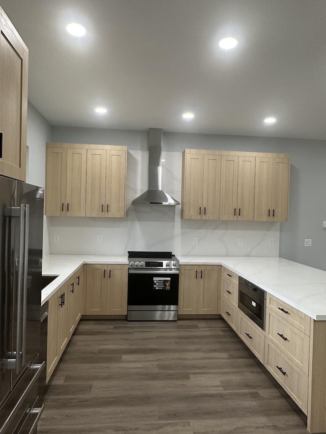 kitchen featuring electric stove, light brown cabinetry, built in microwave, high end refrigerator, and wall chimney exhaust hood