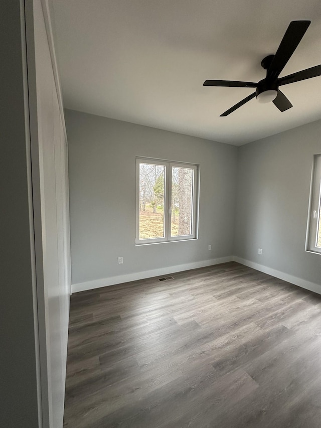 spare room featuring wood-type flooring and ceiling fan