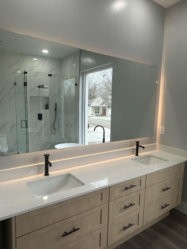 bathroom featuring vanity, wood-type flooring, and walk in shower