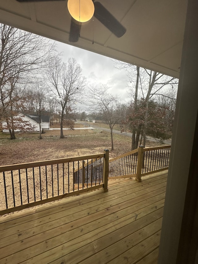 wooden deck featuring ceiling fan