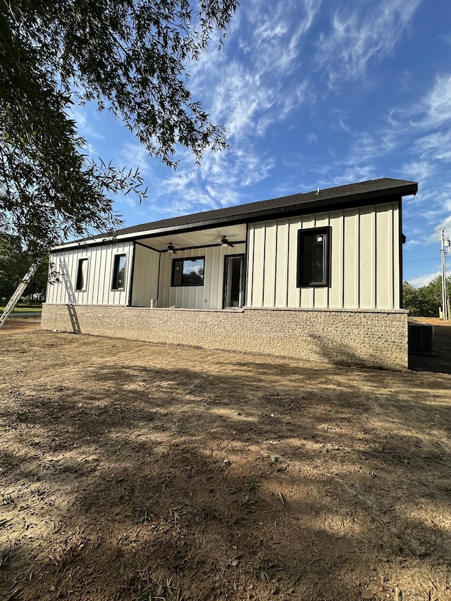 rear view of property featuring ceiling fan