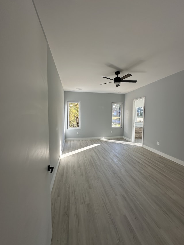 unfurnished room featuring ceiling fan and light wood-type flooring